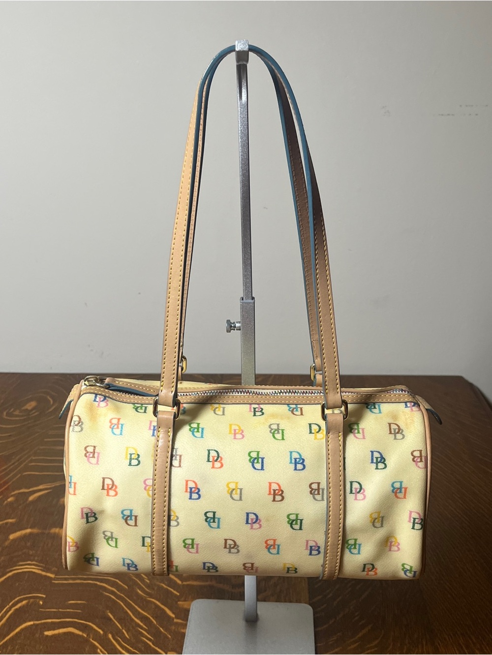 Dooney & Bourke Cream Multicolor DB Monogram Shoulder Barrel Bag.